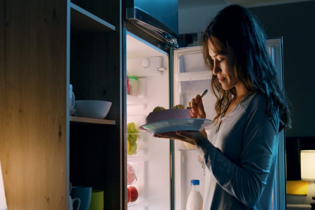 Happy,Hungry,Woman,Having,A,Midnight,Snack,,She,Is,Standing